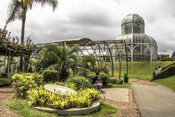 Curitiba, PR, Brazil, December 30, 2017. Tourists in the Botanical Garden of Curitiba, officially denominated Botanical Garden Maria Garfunkel Richbieter, has an iron and glass conservatory inspired by the Crystal Palace and was inaugurated in 1991 i - Photo, Image