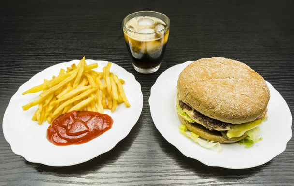 Beef burger and french fries with ketchup and cola on the table. - Photo, Image