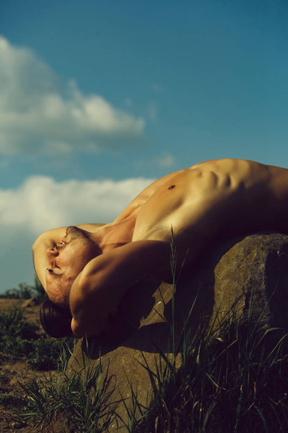 muscular man relaxing on sky backdrop - Foto, Imagem