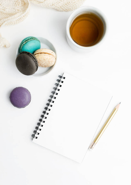 Top view flat lay Blank notebook mockup with macarons and tea cup. Art, writing concept. Text space - Photo, Image