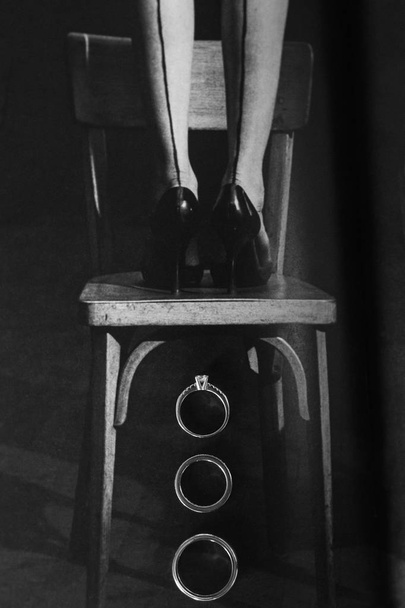 Drie trouwringen onder de stoel. Trouwdag - Foto, afbeelding