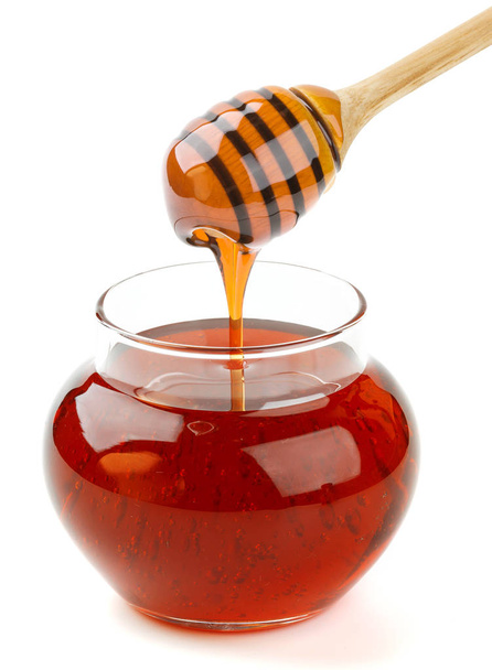 Panela de vidro e pau de mel isolado no fundo branco, mel derramando
 - Foto, Imagem
