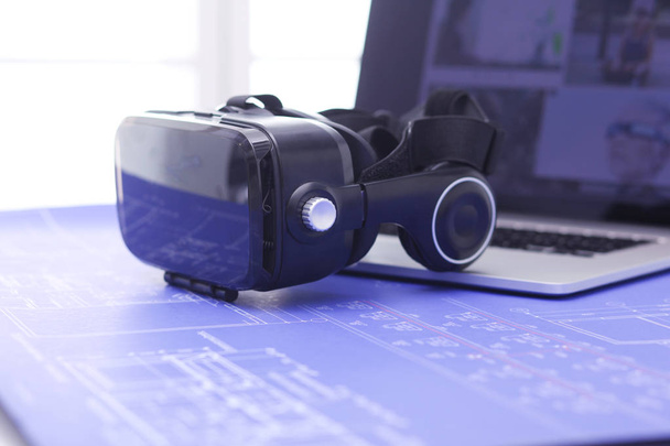 Virtual reality goggles on desk with laptop. business. 3d technology - Φωτογραφία, εικόνα