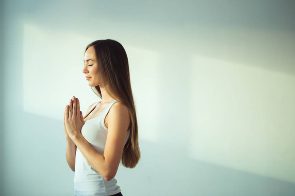 woman practicing yoga and meditation, holding palms together in namaste mudra - Foto, Bild