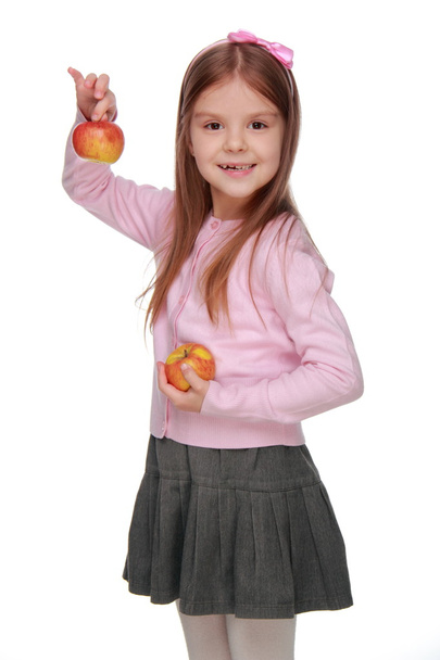 Little girl holding two apples - Fotó, kép