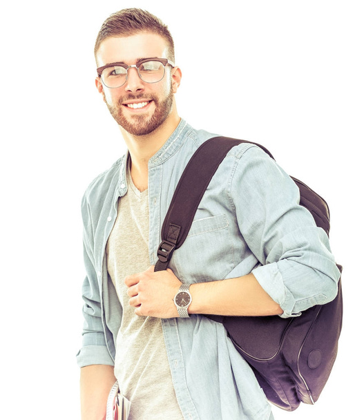Un estudiante masculino con una bolsa de la escuela sosteniendo libros aislados sobre fondo blanco
 - Foto, Imagen