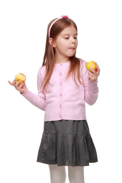 Little girl holding two apples - Фото, изображение