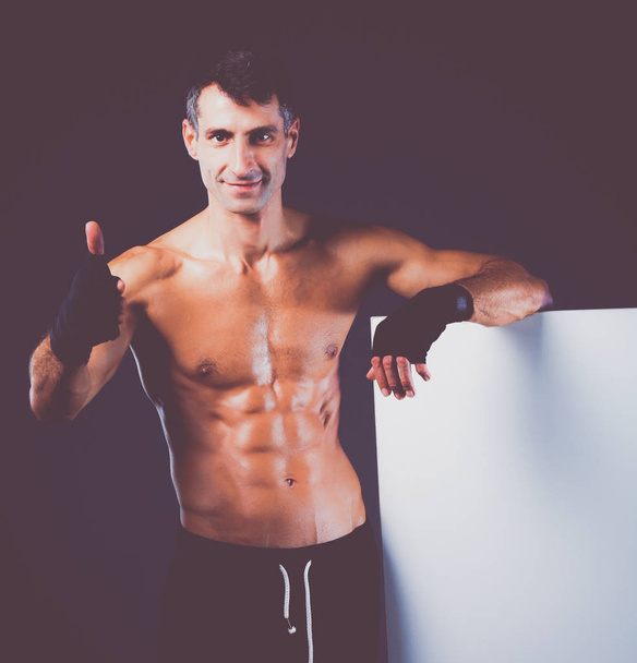 muscular man holding blank - Photo, Image