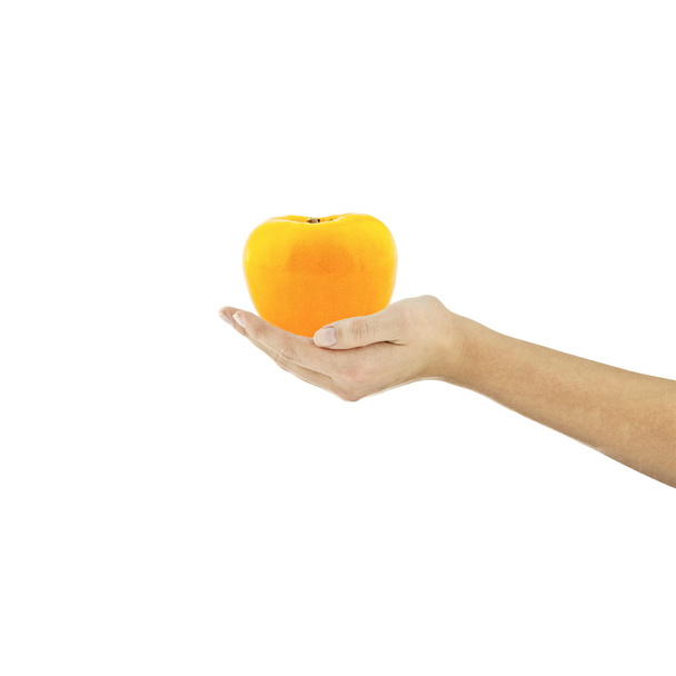 Sharon persimmon owoc bio ręka trzyma palec diety receptury zdrowe sałatki wegetariańskie na białym tle kucharz - Zdjęcie, obraz
