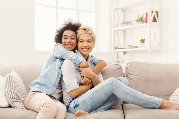 Two female friends embracing each other at home - Photo, Image