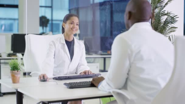 4K Scientists in white coats using interactive touch screen in lab - Video