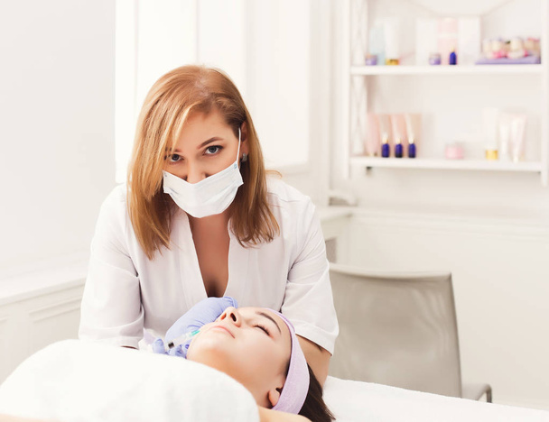 Woman getting beauty injection at salon - Photo, Image