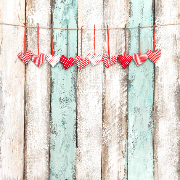 Red hearts decoration hanging Valentines day greetings card - 写真・画像