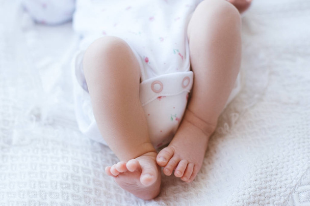 small cute feet newborn bed. - Photo, image