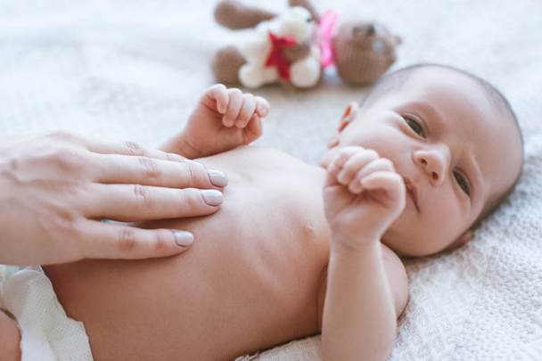 mothers hands gently stroke the newborn baby - Valokuva, kuva