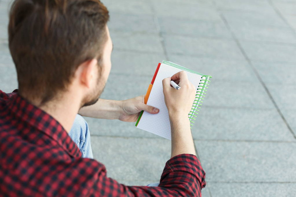 Young student making note, over shoulder shot - Foto, Imagem