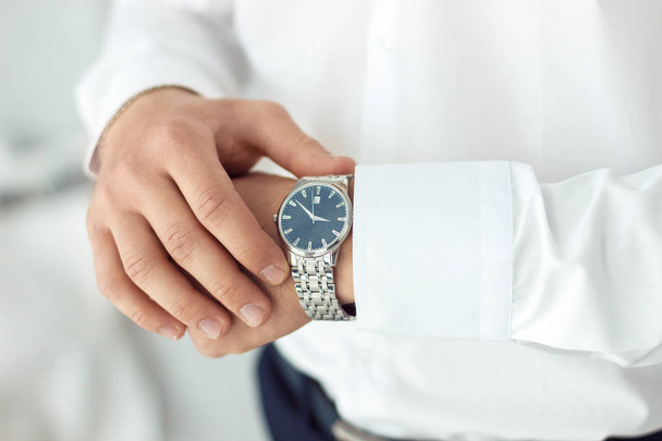 businessman clock clothes, businessman checking time on his wristwatch. men's hand with a watch, watch on a man's hand, putting the clock on the hand, fasten clock watch time, man's style - Fotó, kép
