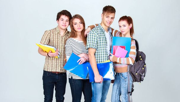 Šťastná skupina studentů, kteří drží zápisníky, izolované na bílém pozadí - Fotografie, Obrázek