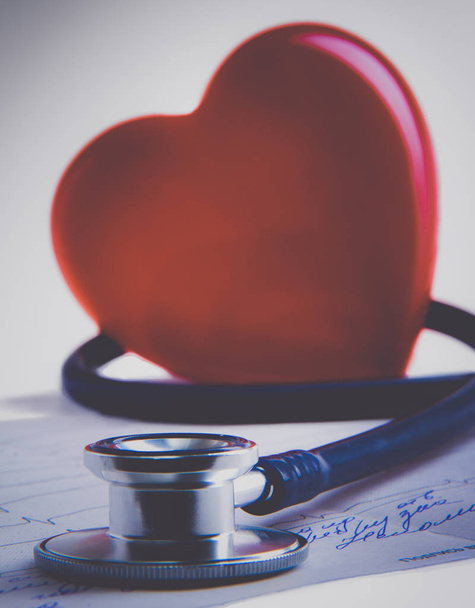 Red heart and a stethoscope on desk - 写真・画像