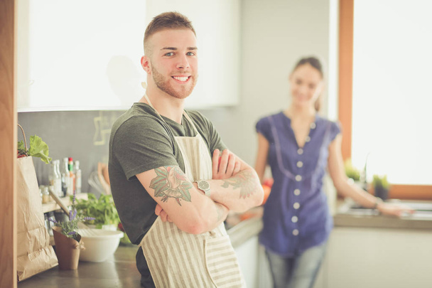 Couple cooking together in their kitchen at home - Photo, image