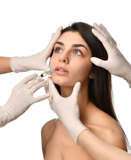 Plastic surgery beauty concept young brunette woman face and  doctor hand in glove with syringe - Foto, Imagem