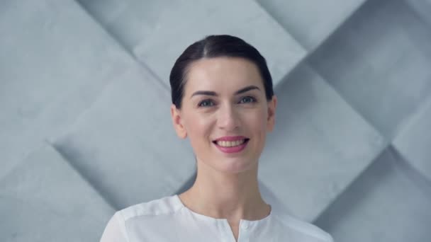 Portrait of beautiful woman smiling into camera - Materiaali, video