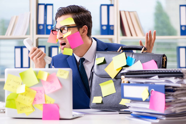 Businessman with reminder notes in multitasking concept - Photo, Image