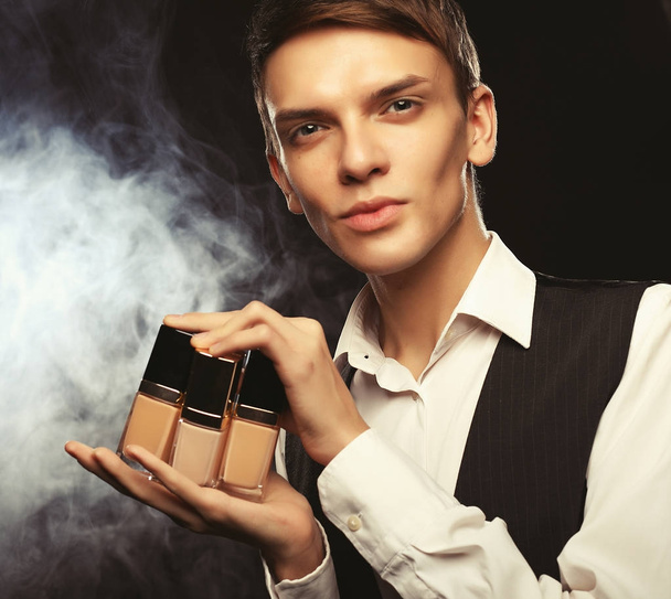 Young male make up artist posing  with foundation for make-up o - Fotoğraf, Görsel