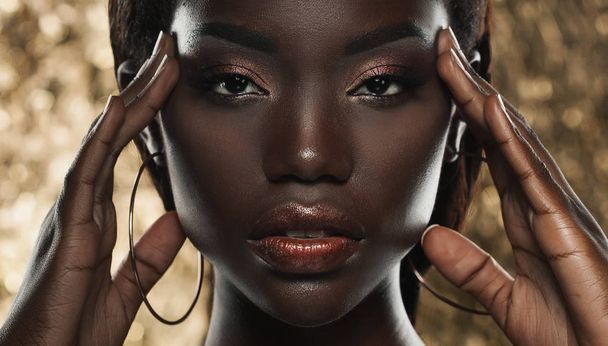 portrait of sensual young african woman against golden background - Foto, Imagem