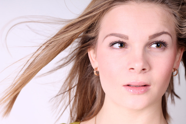Portrait of beautiful girl with long hair blowing in breeze - Foto, Bild