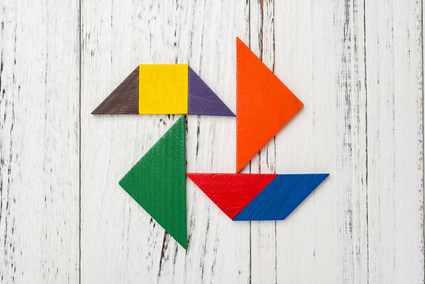 wooden tangram in a pinwheel shape - Foto, Bild