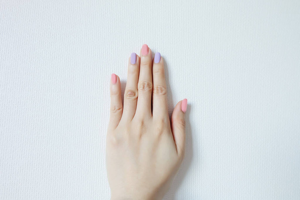 Close Up Nail Polish Manicure. Beautiful Woman is Hands on Pink and Violet Pastel on White Background Great for Any Use. - Fotografie, Obrázek