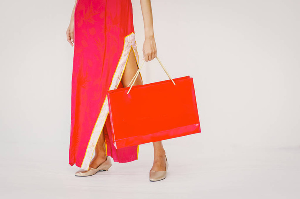 Asian woman holding shopping bag, woman wear cheongsam, chinese  - Zdjęcie, obraz