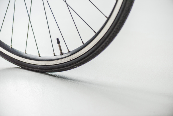 bicycle wheel with rim, tire and spokes with valve on white - Zdjęcie, obraz