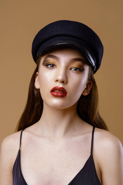 Portrait of gorgeous young fashion model in hat posing on studio background  - Foto, Imagem