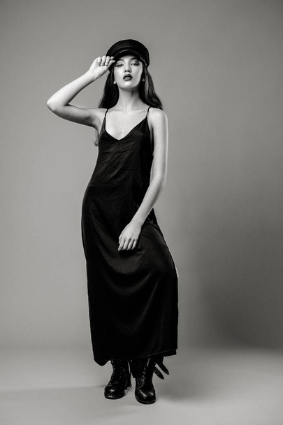 Black and white full length portrait of gorgeous young fashion model posing on studio background  - Valokuva, kuva