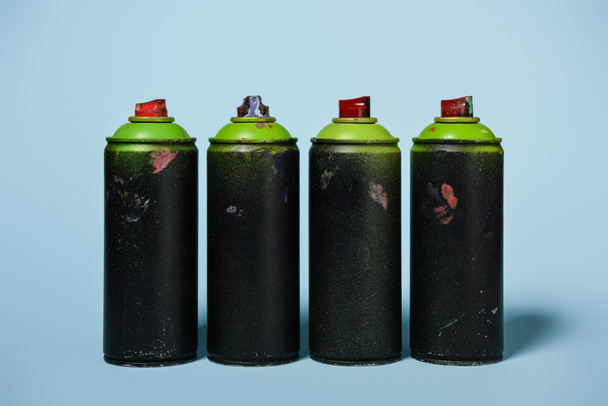 close up view of arranged cans with aerosol paint isolated on blue - Photo, Image