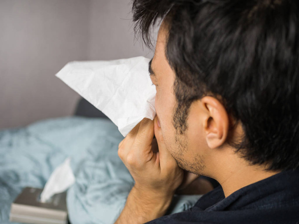 Man blow his nose with tissue paper flying - Fotó, kép