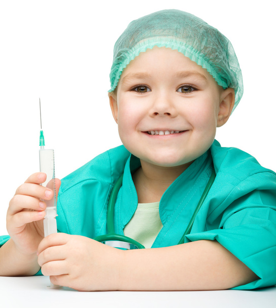 Cute little girl is playing doctor with syringe - Φωτογραφία, εικόνα