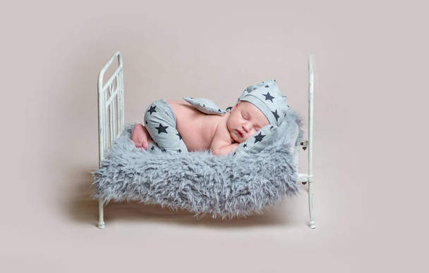 Sweet newborn boy on small cot sleeping - Фото, зображення