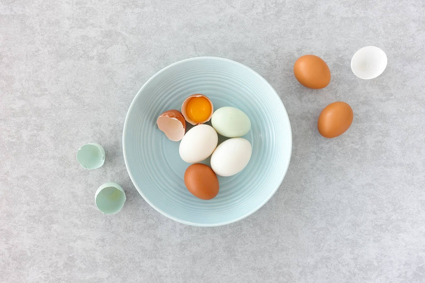 Blue, Brown and White Duck Eggs in a Blue Bowl   - Fotó, kép