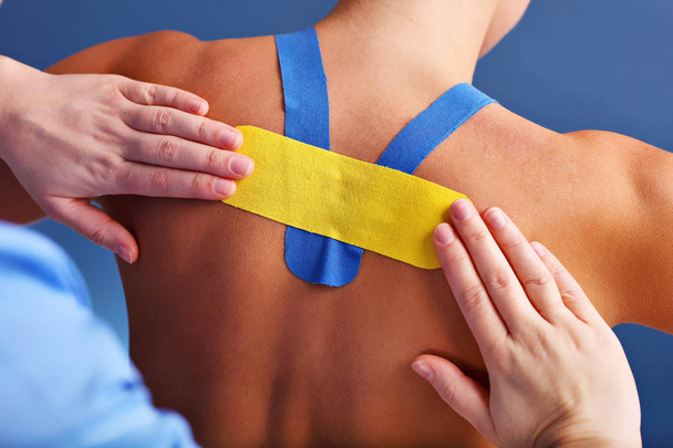 Picture showing special physio tape put on injured back over white background - Photo, Image