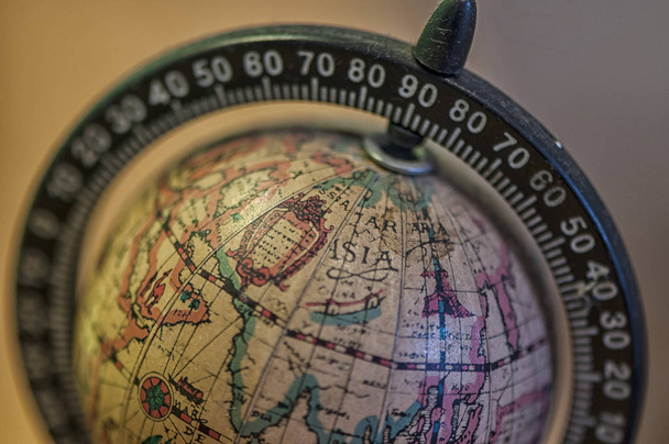 Close-up on a small globe with focus on Asia - Foto, afbeelding