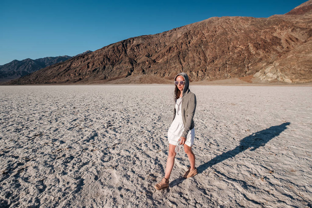 Tourist in Badwater Basin at hot summer day, Death Valley National Park, California, USA. - Фото, зображення