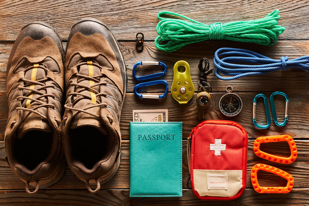 Travel items for hiking tourism flat lay still life over wooden background - Photo, Image