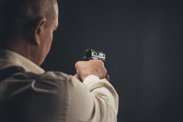 close-up shot of security man aiming with gun - Zdjęcie, obraz