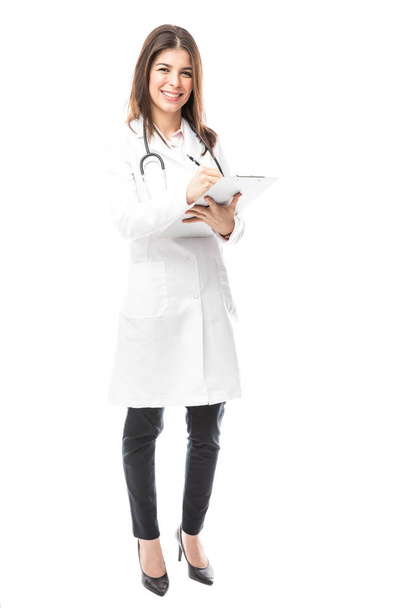 beautiful female doctor taking notes - Zdjęcie, obraz