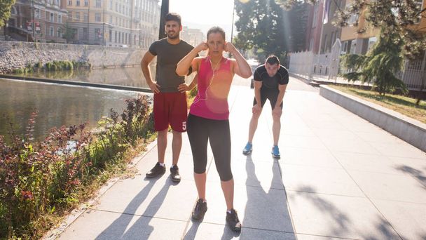 group of young sporty people jogging at sunny morning in the city - Photo, Image