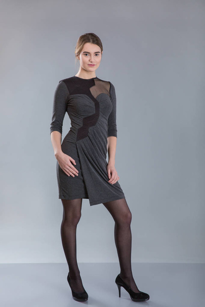 business woman wearing gray dress staying full-length - Photo, Image