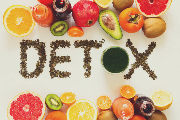 Healthy eating concept. Word 'detox' from green tea with colorful smoothies and fruits. Top view. Toned - Foto, immagini